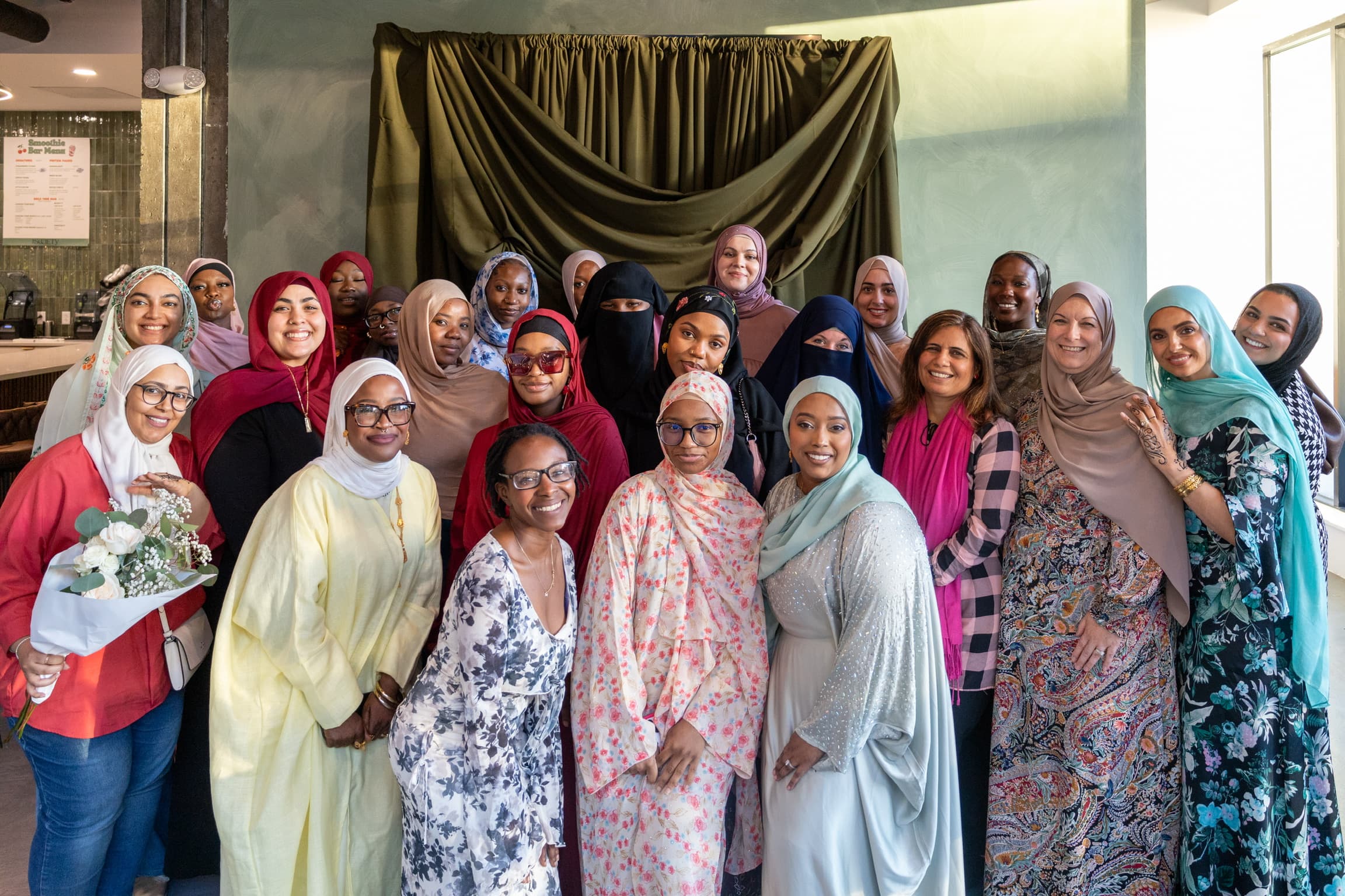 Large group of women celebrating together indoors, photographed by ShuhraBilNoor