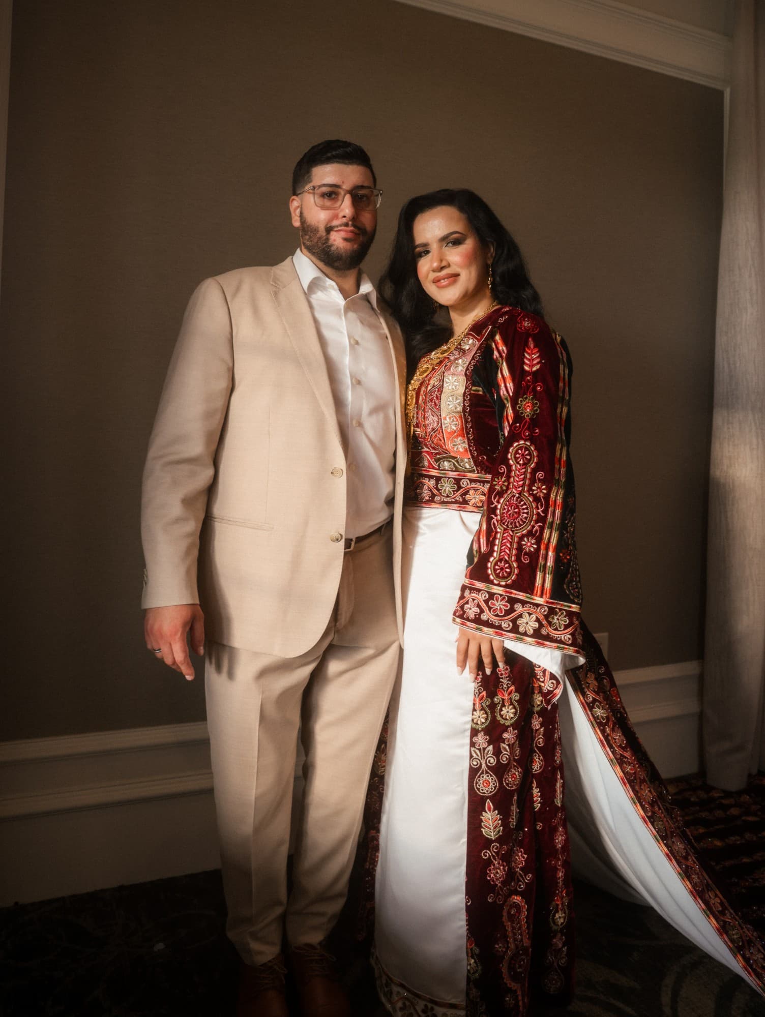 Couple in traditional nikkah attire posing together, photographed by ShuhraBilNoor